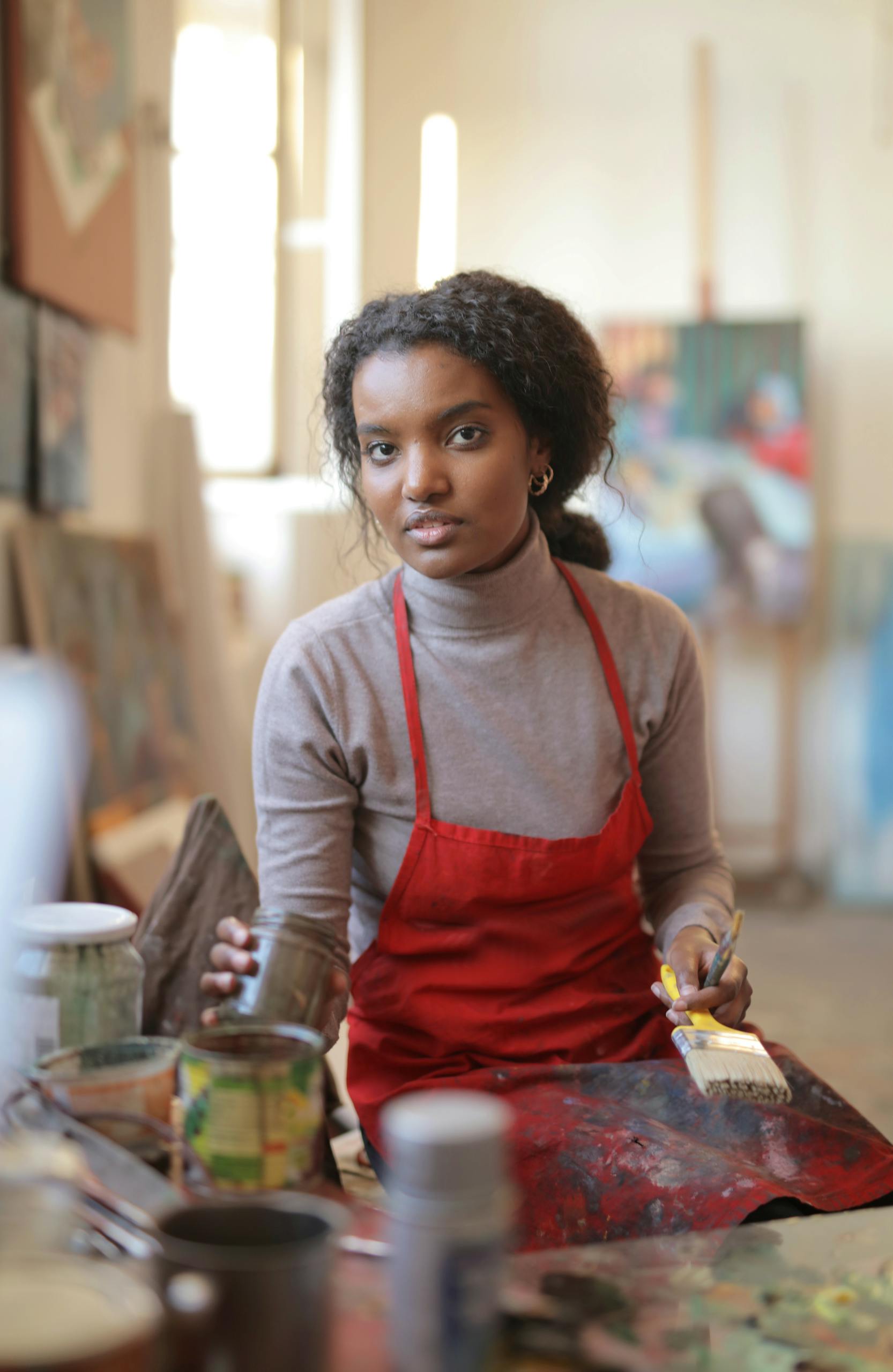 Creative young woman working in workshop