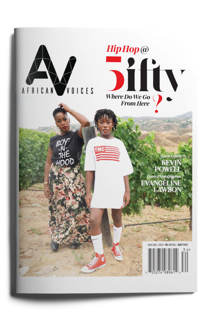Cover of African Voices magazine featuring two individuals standing outdoors. One wears a brown outfit and head scarf, while the other sports a white T-shirt dress with an American flag. The headline reads "Hip Hop @ Fifty: Where Do We Go From Here?". Guest Editor: Kevin Powell.